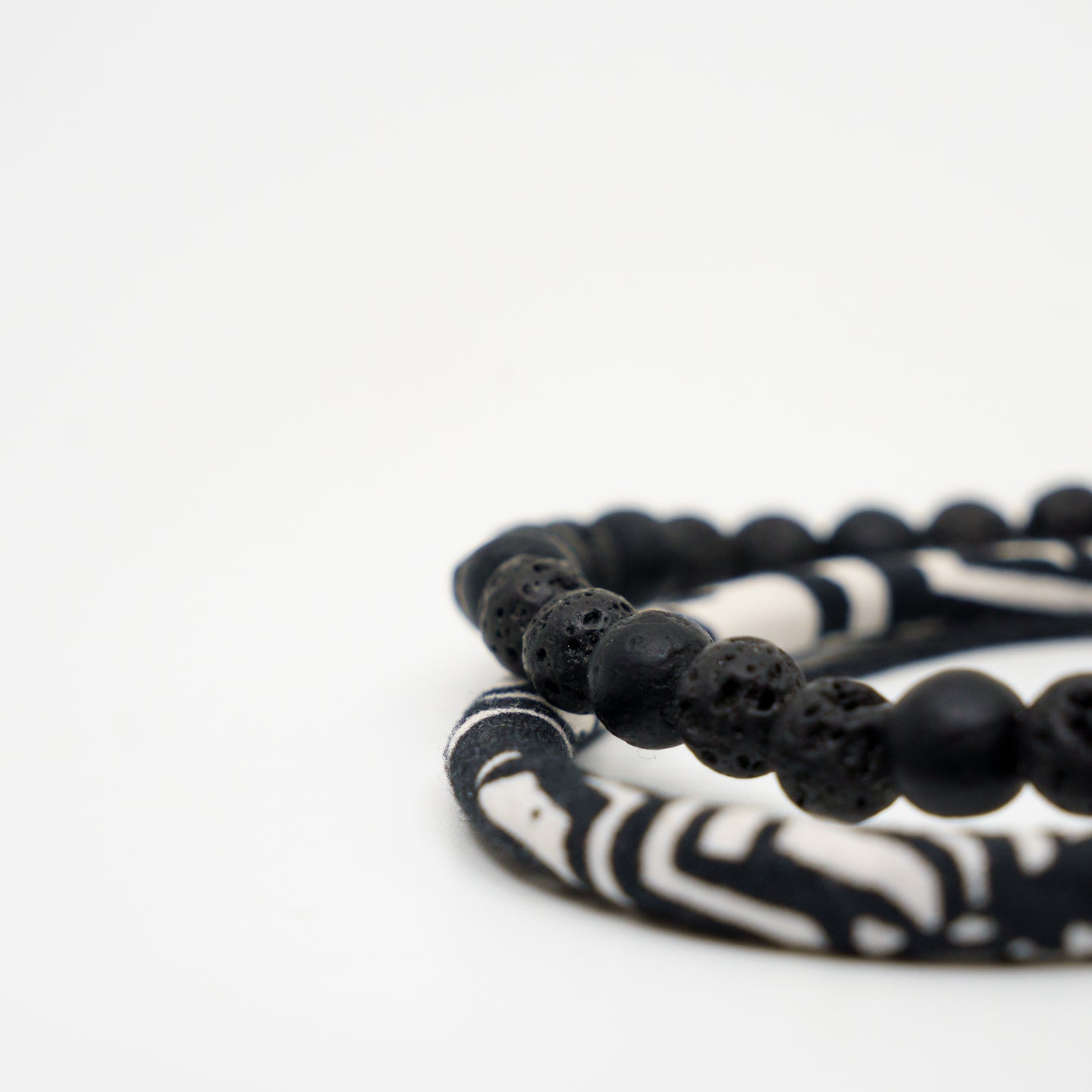 Noir beads stacked with a raven band.